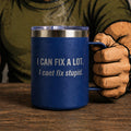 Blue mug with text held by a person wearing gloves on a wooden surface