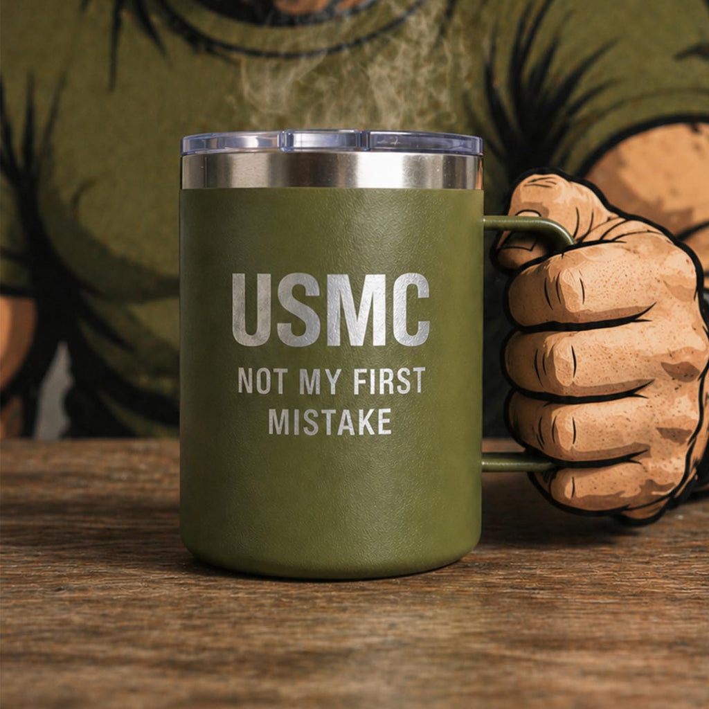 Green mug with 'USMC Not My First Mistake' text held by a person wearing a green shirt and brown gloves.